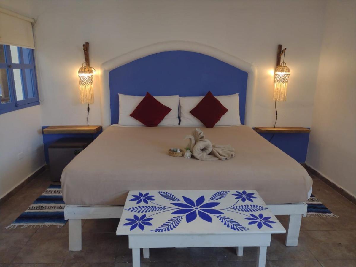 Mio Tulum Hotel Boutique Bagian luar foto A bedroom in a hotel in Santorini, Greece